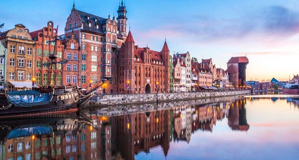 Photo of panorama of the facades of old medieval houses on the promenade in Gdansk, Poland.