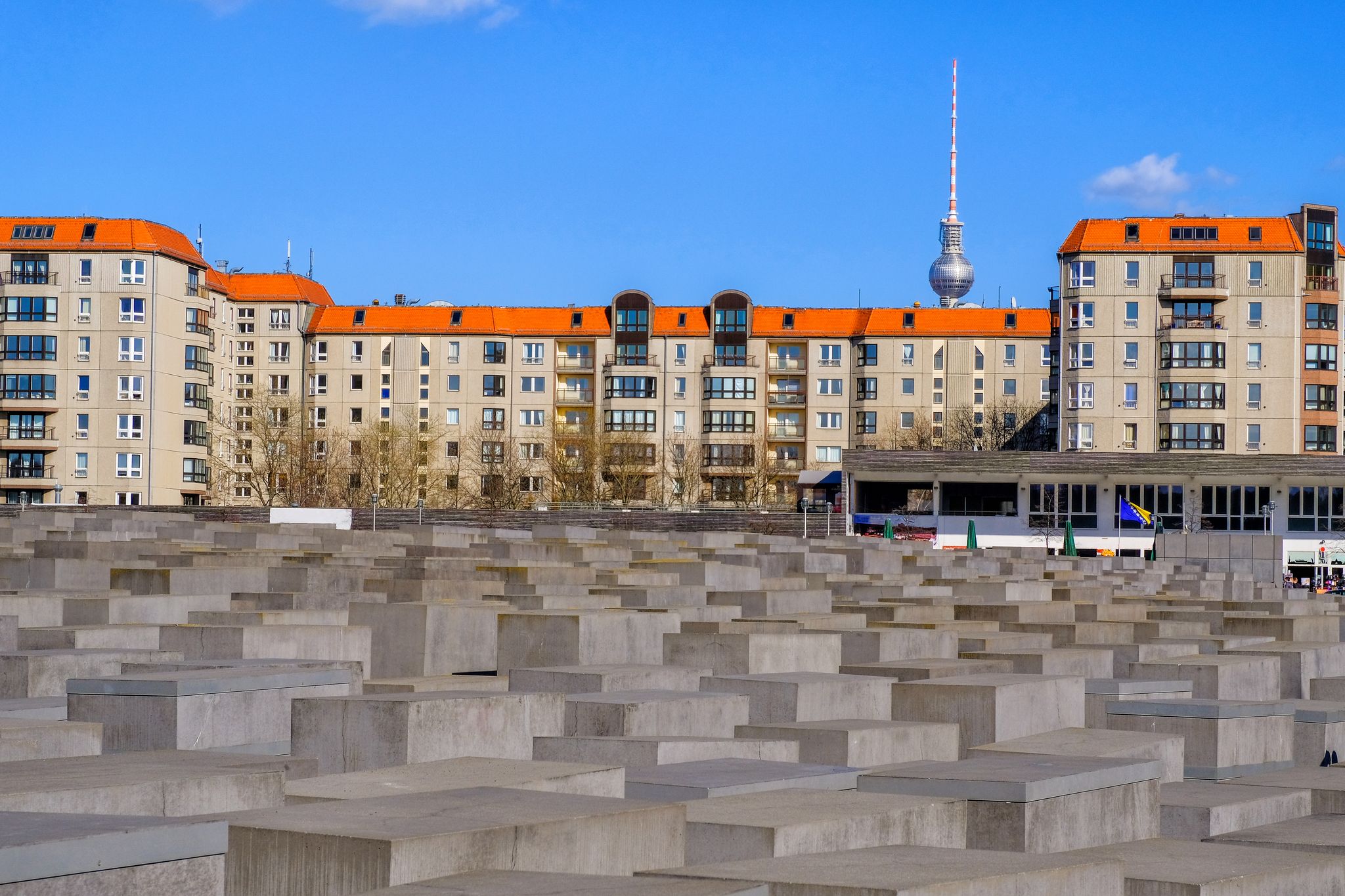 Photo of Holocaust Memorial museum and Berlin city skyline in daylight, Berlin, Germany.