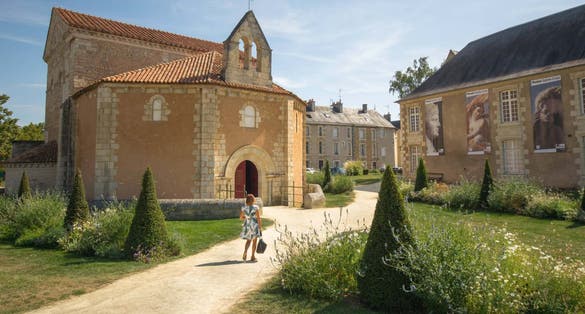 photo of a woman visiting the Baptistery of St. John (Baptistere Saint-Jean), which is a Roman Catholic church in Poitiers, France.