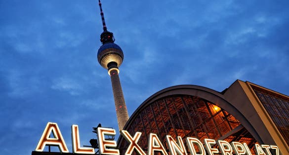 Photo of Night shot of the train station Berlin Alexanderplatz with the famous TV tower in the background.
