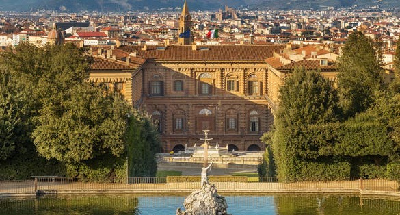photo of The Boboli Gardens park, Fountain of Neptune and a distant view on The Palazzo Pitti, in English sometimes called the Pitti Palace, in Florence, Italy. Popular tourist attraction and destination.