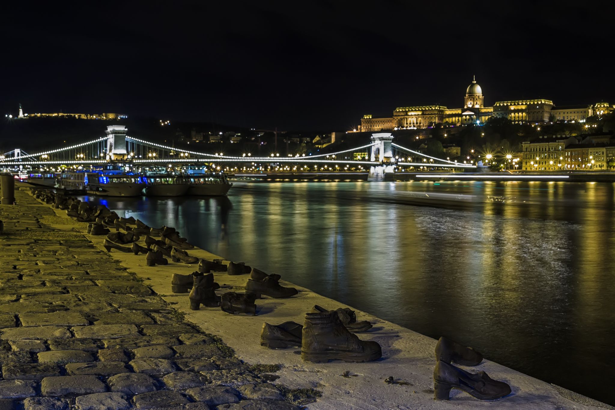 Photo of Shoe Monument on the Banks at night of the river Danube in Budapest.