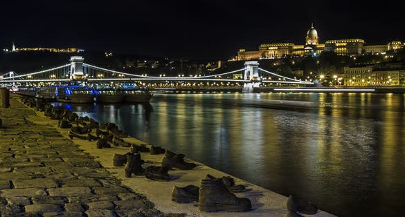 Photo of Shoe Monument on the Banks at night of the river Danube in Budapest.