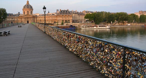 photo of the hundreds of thousands of romantically love inscribed padlocks on the Pont des Arts Bridge, Paris, France.