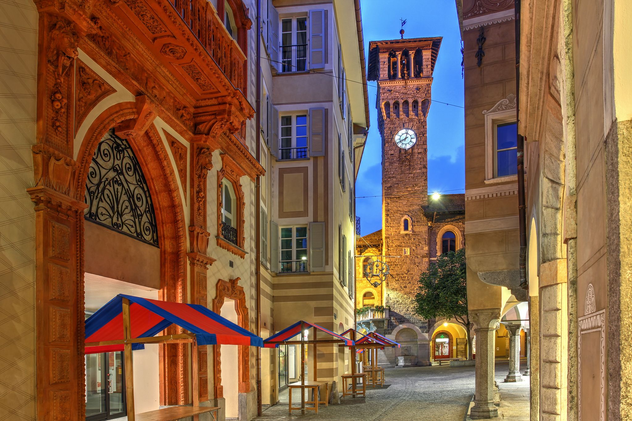 Photo of Night street scene in Piazza Nosetto featuring the tower of the Town Hall (Palazzo Civico) in Bellinzona, Switzerland.