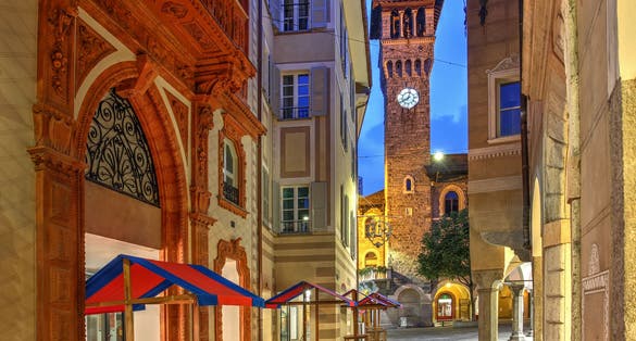 Photo of Night street scene in Piazza Nosetto featuring the tower of the Town Hall (Palazzo Civico) in Bellinzona, Switzerland.