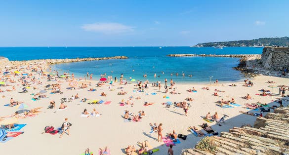  People sunbathing on Plage de la Gravette in Antibes.