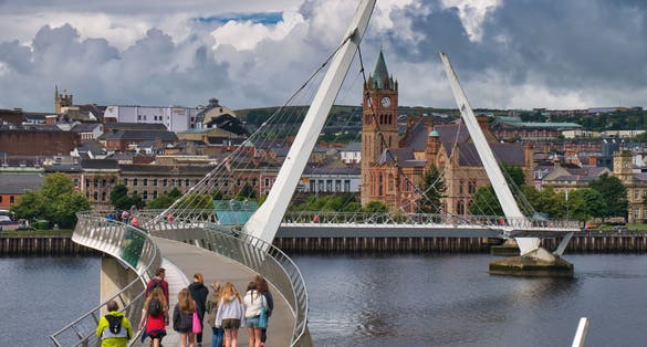 The Peace Bridge across the River Foyle in Derry - Londonderry in Northern Ireland, UK. The bridge links the "Waterside" and "Cityside" areas of the city.