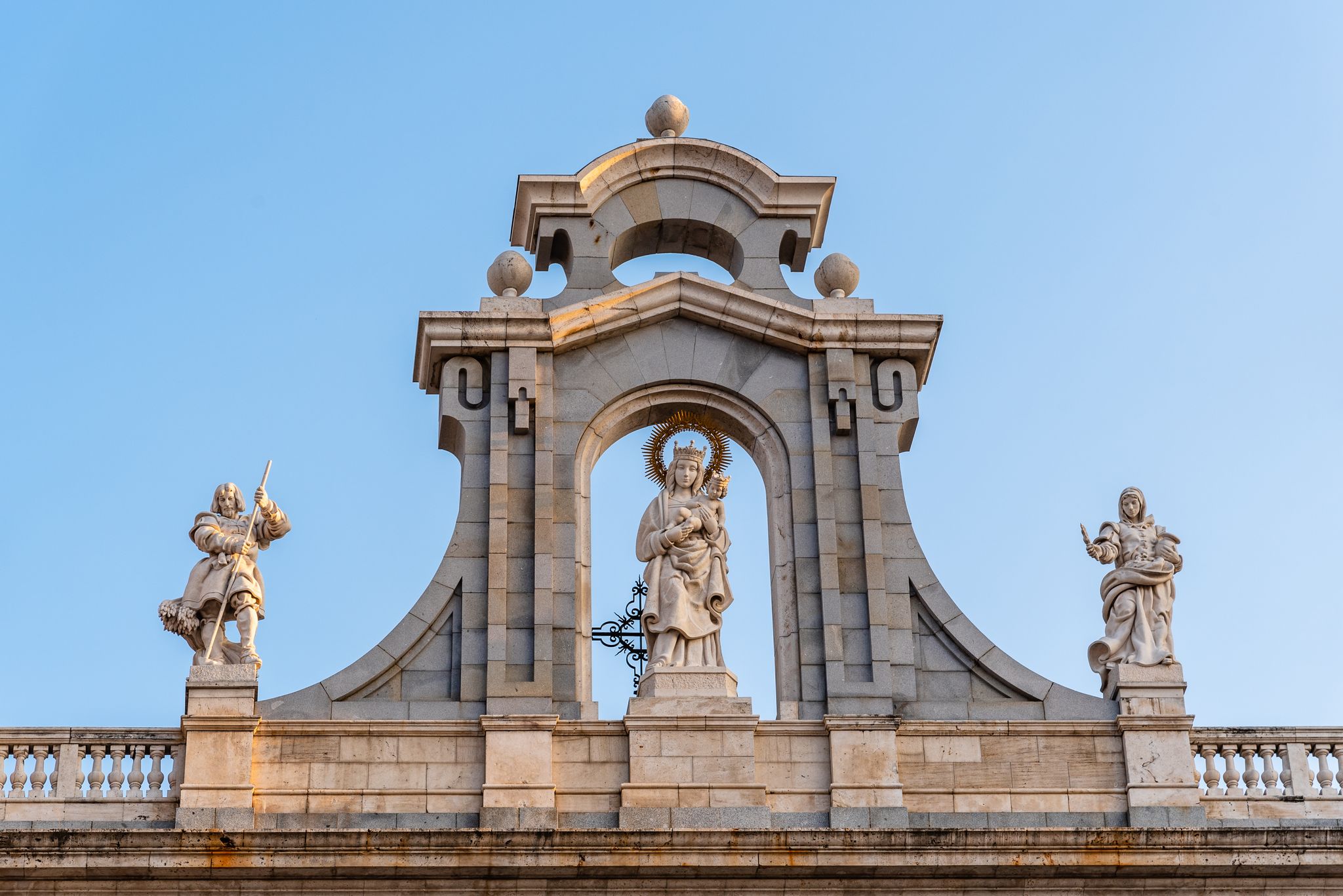 Photo of Almudena Cathedral of Madrid. Exterior detail of Virgin Sculpture above entrance.