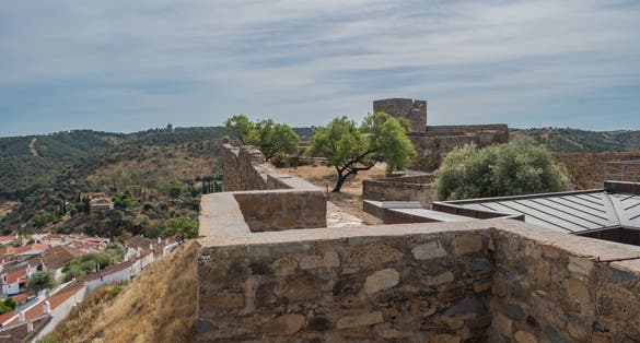 Photo of Wall of the Castle of Mértola on a hill with houses, Alentejo PORTUGAL.