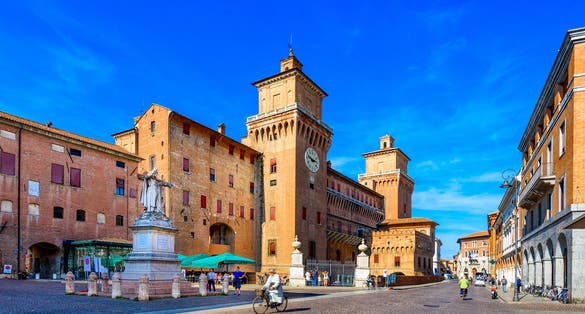 Castle Estense (Castello Estense) and piazza Savonarola and monumet to Savonarola in Ferrara, Emilia-Romagna, Italy. Ferrara is capital of the Province of Ferrara