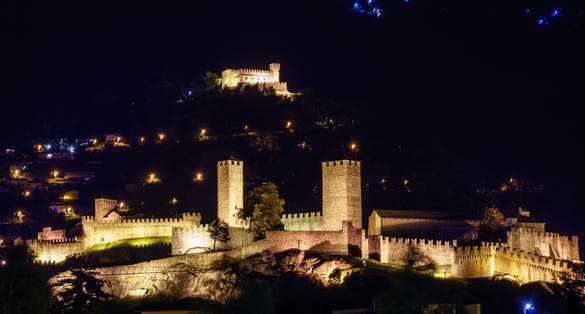 photo of ancient Castles of Bellinzona at night in Ticino, Switzerland.