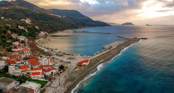 Photo of aerial view of the coastal seaside village Loutraki with it's beautiful beach, Greece.
