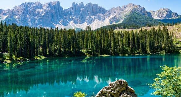 photo of view of Carezza lake (Lago di Carezza, Karersee) with Mount Latemar, Bolzano province, South Tyrol, Italy.
