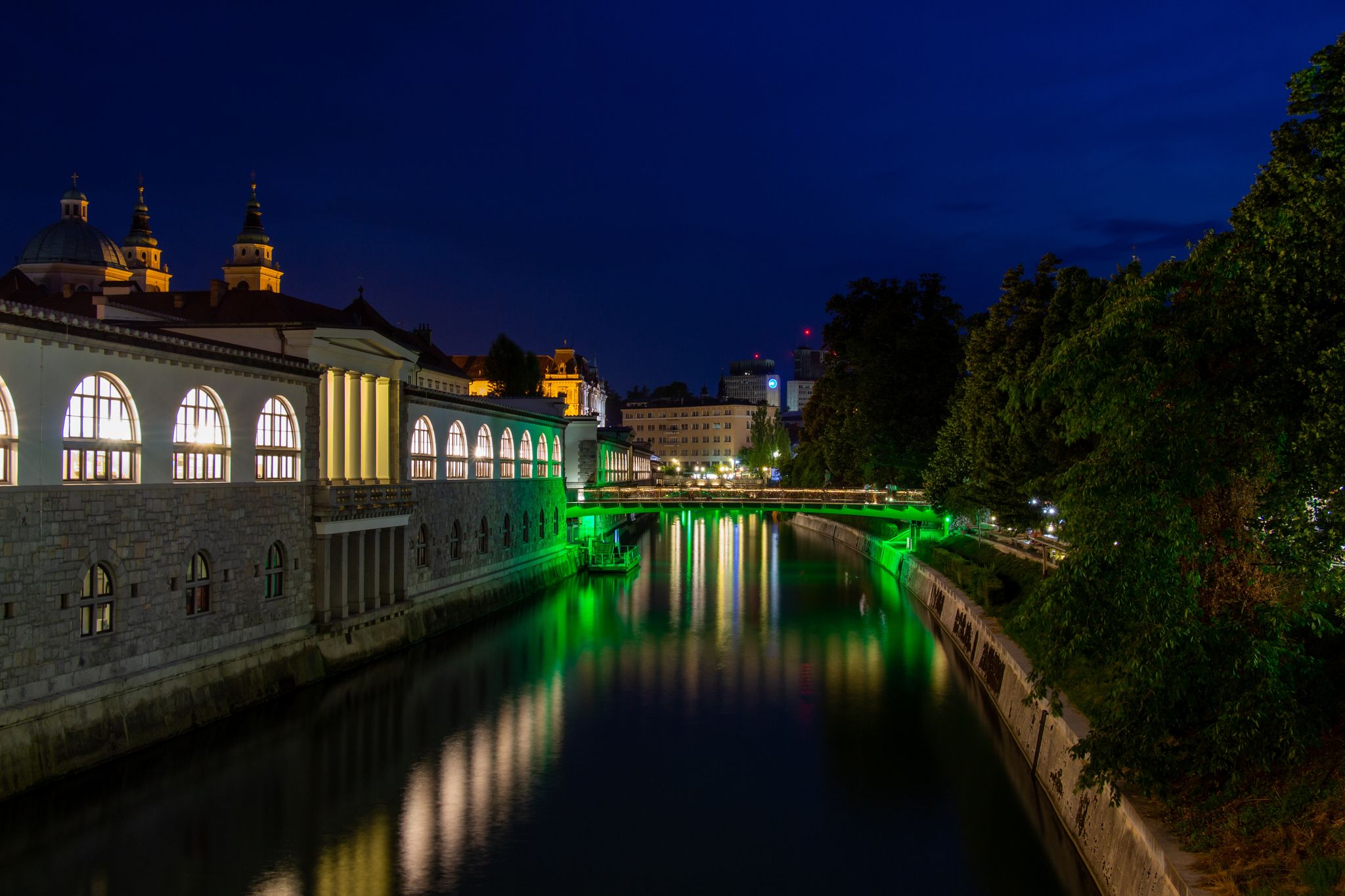 Photo of Ljubljana, Slovenia, view of the Ljubljanica River by night and the illuminated Butchers' Bridge.