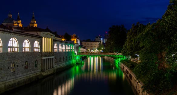 Photo of Ljubljana, Slovenia, view of the Ljubljanica River by night and the illuminated Butchers' Bridge.