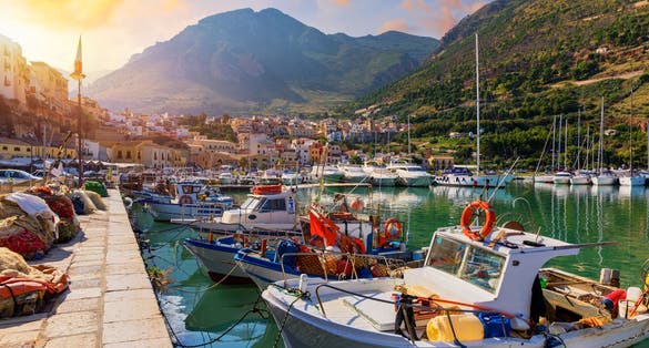 Sicilian port with fishing boats of Castellammare del Golfo village of Sicily, Trapani, Italy. Castellammare del Golfo town (Gulf of Castellammare) on Mediterranean Sea, Trapany, Sicily, Italy.