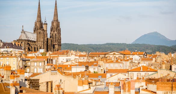 photo of view of Morning aerial cityscape view on Clermont-Ferrand city with beautiful cathedral and mountains on the background in central France