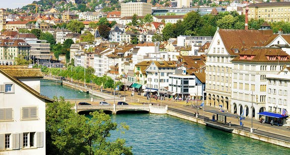 Photo of bridge at Limmatquai in the city center of Zurich, Switzerland. People on the background. Seen from Lindenhof hill.