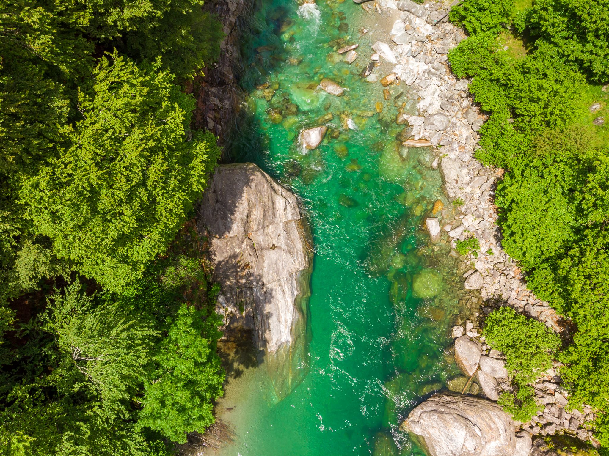 photo of Valle Verzasca - Aerial view of clear and turquoise water stream and rocks in Verzasca River in Ticino - Verzasca Valley in Tessin, Switzerland.
