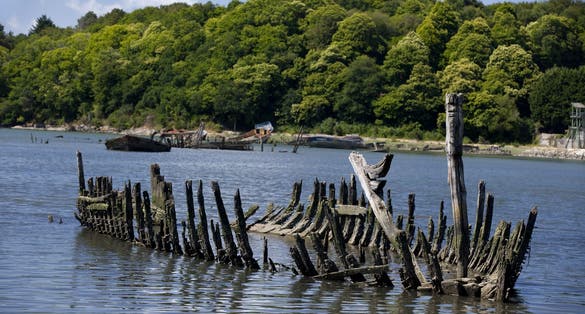 Abandoned boat structure. Flotsam of an old wooden boat abandoned in a ship graveyard. Lorient, Brittany, France.
