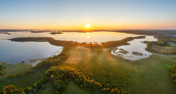 photo of ariel view of Sunrise in National Park Narachanski, Minsk, Belarus.