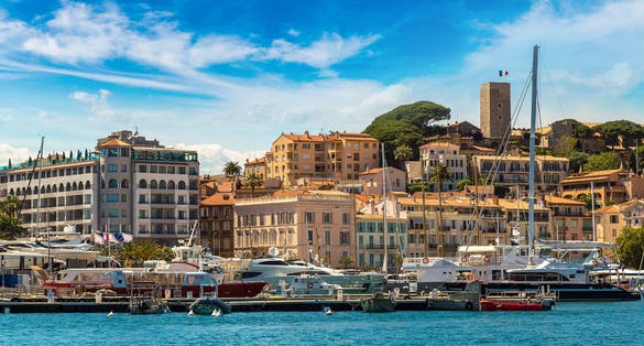 Yachts anchored in port in Cannes in a beautiful summer day, France.