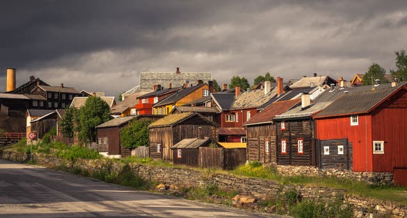 photo of view of Old street architecture of mining town Roros in Norway. Wooden, colorful buildings. UNESCO world heritage list.