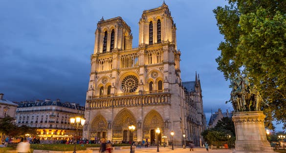 Photo of Notre Dame cathedral in Paris at night, France.