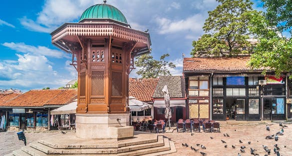 Photo of Bascarsija square with Sebilj wooden fountain in Old Town Sarajevo , Bosnia and Herzegovina.