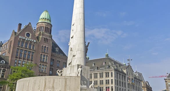 photo of The National Monument on the Dam and in the background the Royal Palace in Amsterdam the Netherlands.