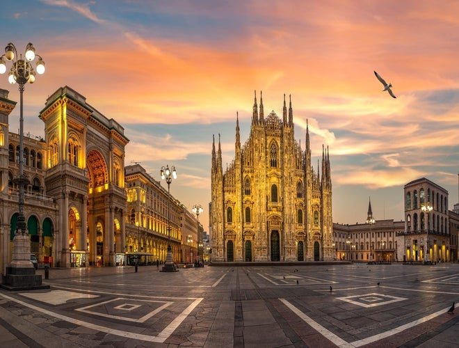 Piazza del Duomo in Milan at sunset with the cathedral illuminated and clear skies overhead..jpg
