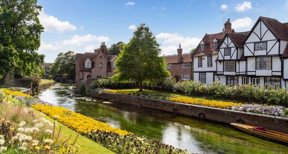 The Great Stour river flows past beautiful old half-timbered houses at Westgate Gardens in the picturesque English town of Canterbury.