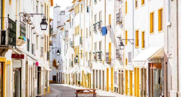 Photo of Street view with beautiful old residential buildings in Evora city in Portugal.