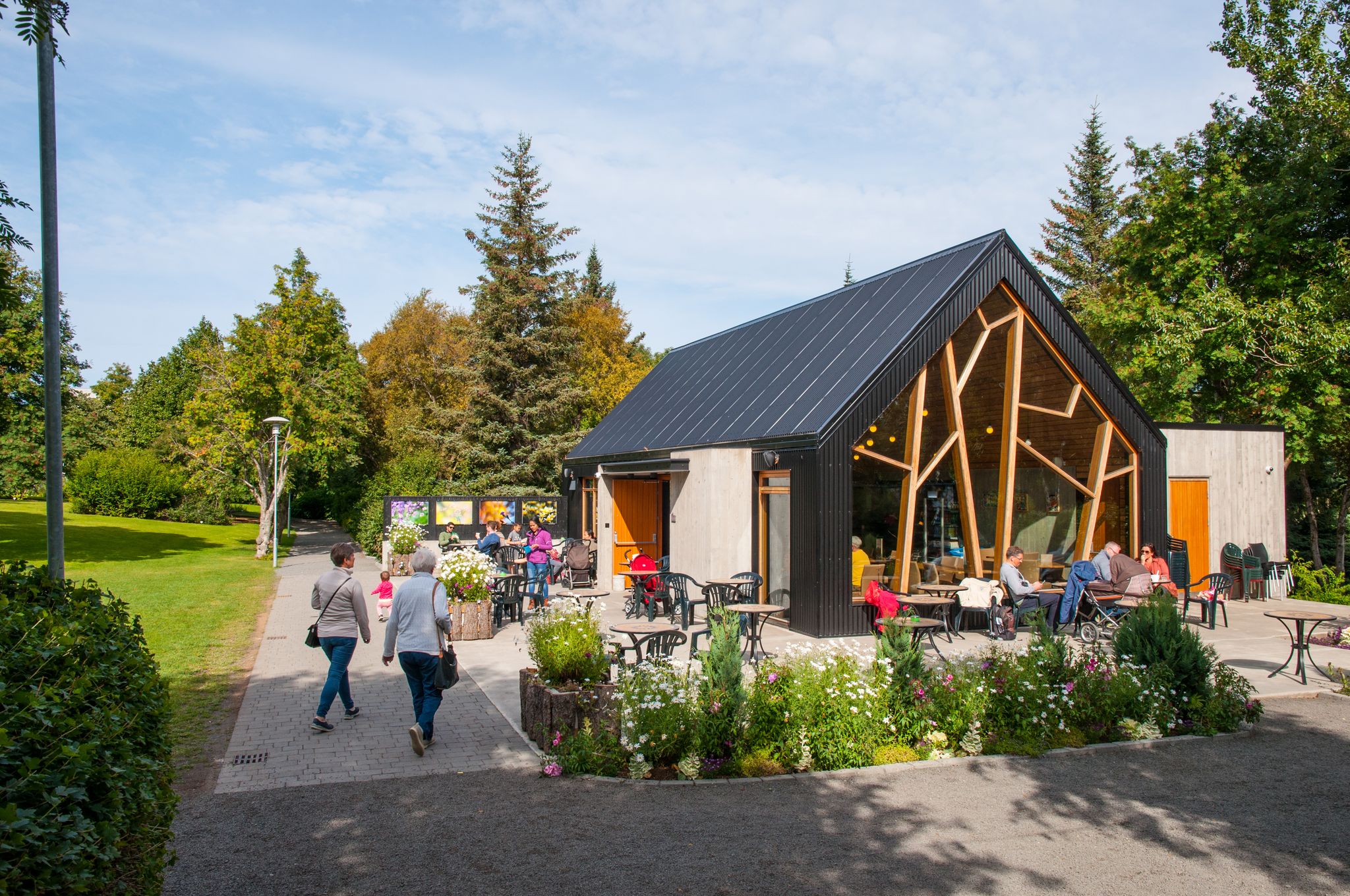 photo of akureyri, Iceland - August 22. 2017: people eating at a coffee shop in akureyri botanic garden.