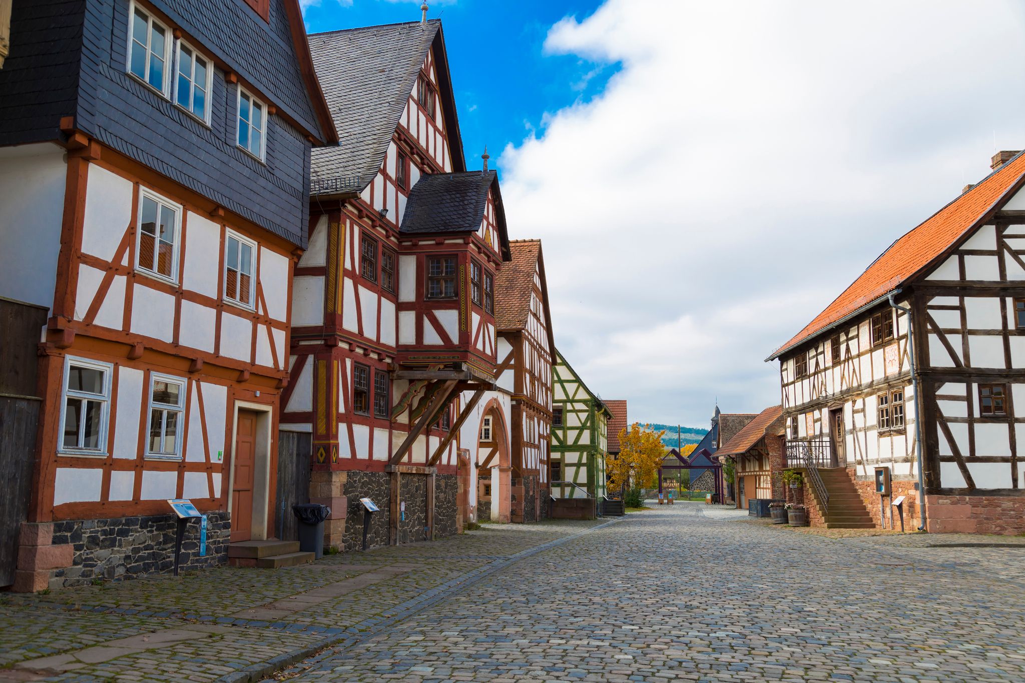 Hessenpark - open-air museum in Hesse, Germany is a popular family destination . Ancient colorful historical half-timbered buildings on stone street .