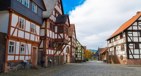 Hessenpark - open-air museum in Hesse, Germany is a popular family destination . Ancient colorful historical half-timbered buildings on stone street .