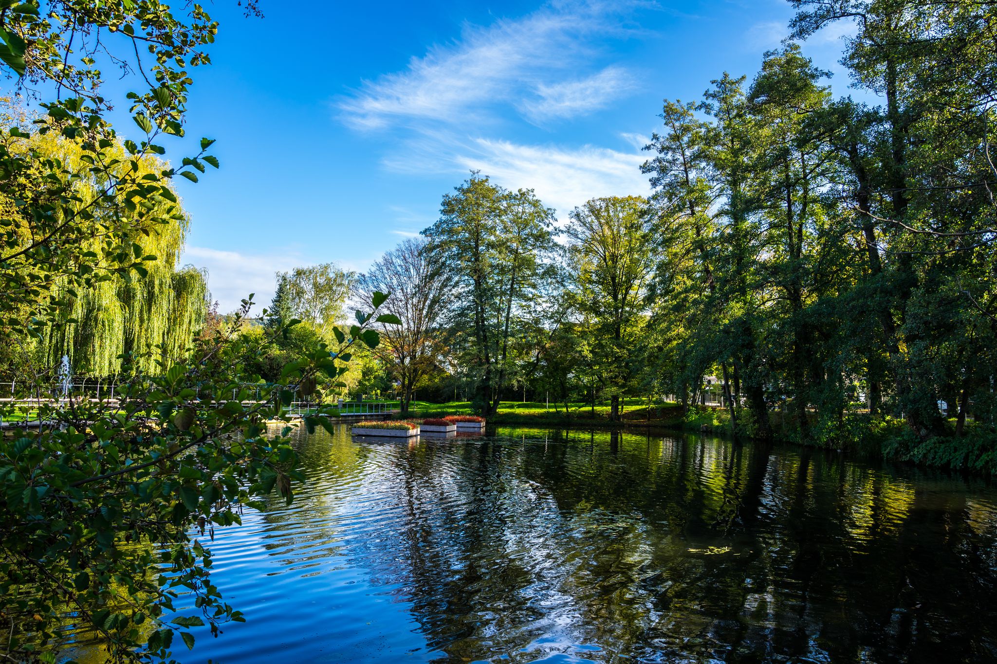 Germany, Public park called feuersee in schorndorf city near pedestrian zone with a small lake and fountains surrounded by trees, perfect for relaxation