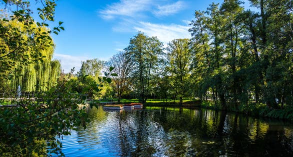 Germany, Public park called feuersee in schorndorf city near pedestrian zone with a small lake and fountains surrounded by trees, perfect for relaxation