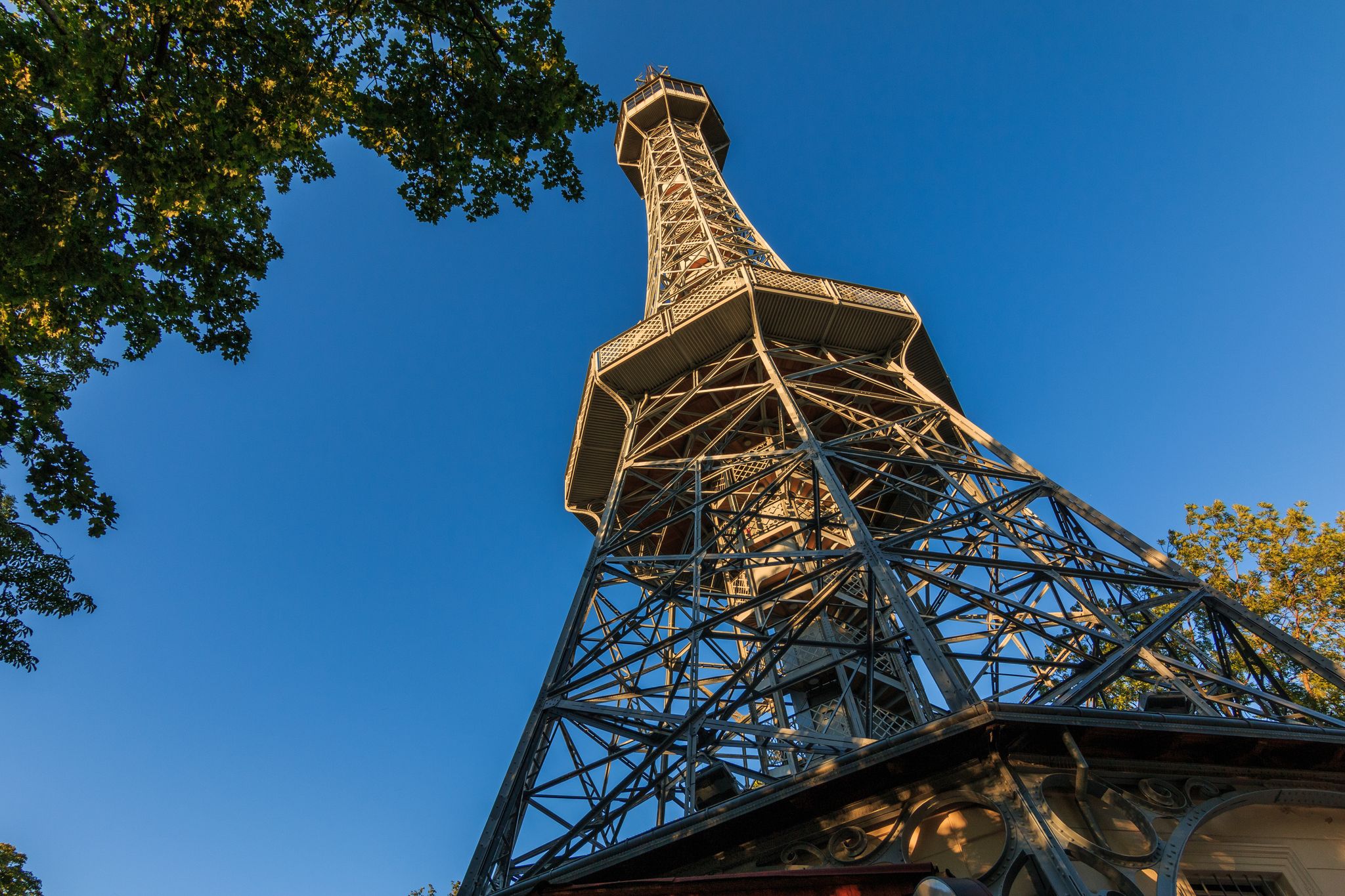 Photo of Old Petrin radio tower made of steel in Prague on the Petrin hill with view from the pedestal in the district Lesser Town, Czech Republic.