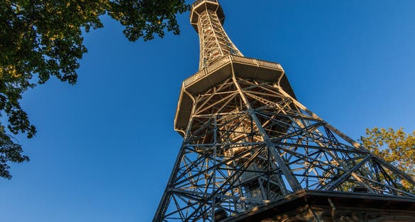 Photo of Old Petrin radio tower made of steel in Prague on the Petrin hill with view from the pedestal in the district Lesser Town, Czech Republic.
