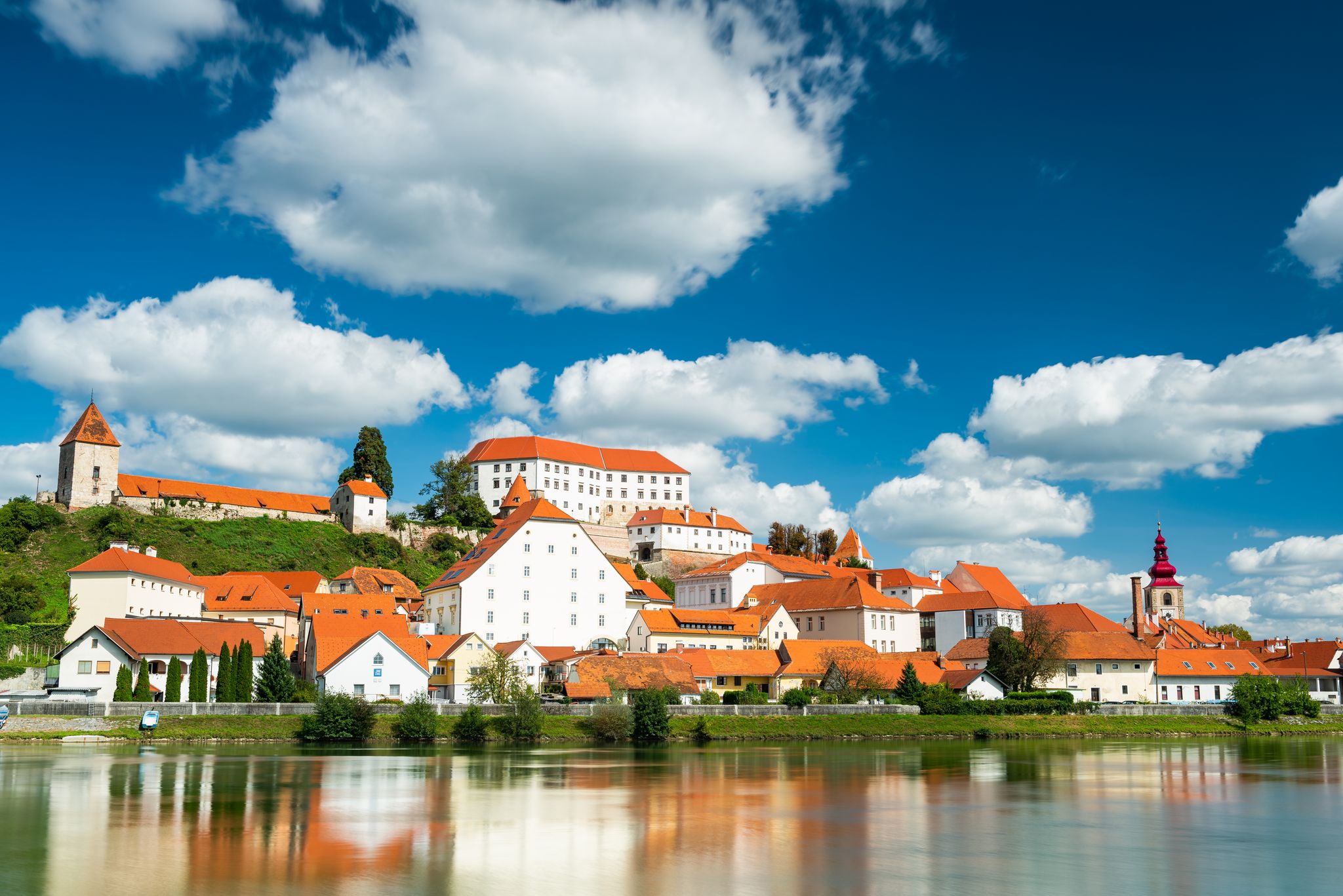 Photo of Beautiful Ptuj Grad in Slovenia with Castle and Fortifications at River Drava.