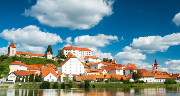 Photo of Beautiful Ptuj Grad in Slovenia with Castle and Fortifications at River Drava.