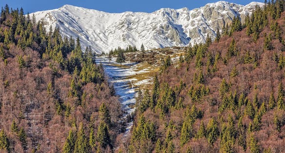 Photo of Piatra Craiului mountains peaks covered by snow, Brasov county, Romania.
