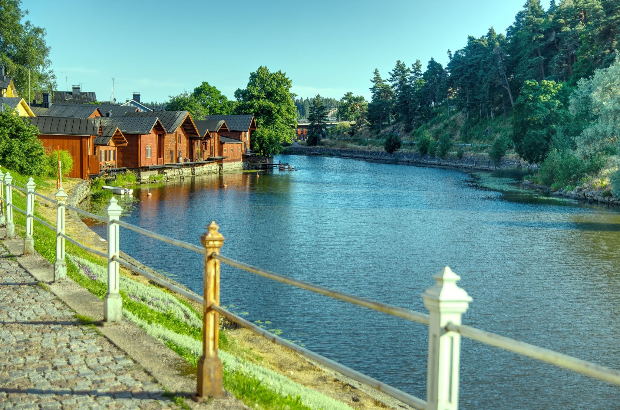 Walking on a historical cobbled coastal harbor street with nice fence posts in Porvoo Finland