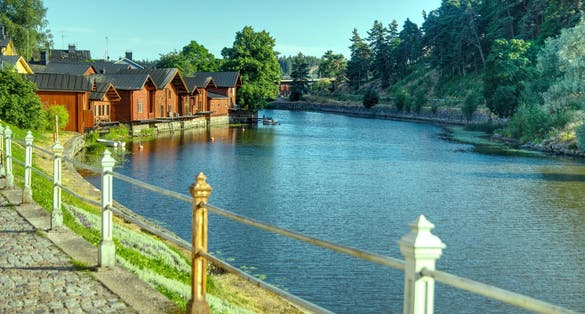 Walking on a historical cobbled coastal harbor street with nice fence posts in Porvoo Finland