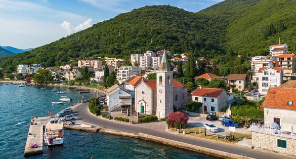 Photo of aerial view of the waterfront orthodox church of Saint Roch of Donja Lastva in Tivat in the Bay of Kotor, Montenegro.