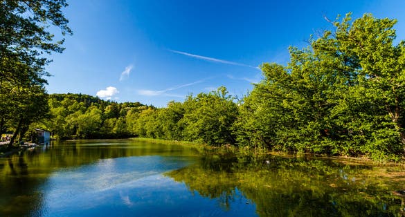 Tivoli Pond in spring. View towards north, with Roznik Hill in the background. Tivoli City Park, Ljubjana, Slovenia.