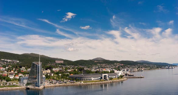 photo of view of Seaside view of Molde, Norway. The city is located on the northern shore of the Romsdalsfjord and is nicknamed ‘The Town of Roses’.