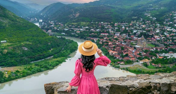 Photo of tourist visiting Jvari Monastery and Mtskheta city in Georgia.